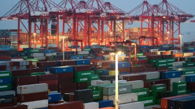 Gantry cranes stand near stacked shipping containers at Yangshan Port outside Shanghai, China, May 7, 2026. REUTERS/Go Nakamura