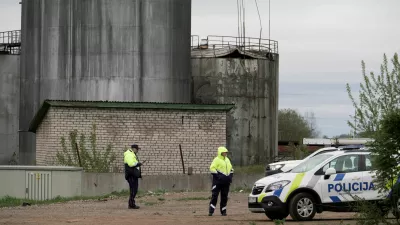 Police officers stand at the site of damage after drones crashed at a storage facility in Rezekne, Latvia, May 7, 2026. REUTERS/Janis Laizans   TPX IMAGES OF THE DAY
