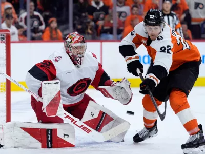 Carolina Hurricanes' Frederik Andersen, left, blocks a shot as Philadelphia Flyers' Christian Dvorak reaches in during the second period of Game 3 in the second round of the NHL hockey Stanley Cup playoffs, Thursday, May 7, 2026, in Philadelphia. (AP Photo/Matt Slocum)
