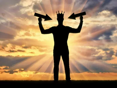 Silhouette of a selfish man with a crown on his head tries to attract attention by holding pointer in his hands. The concept of a selfish and narcissistic personality