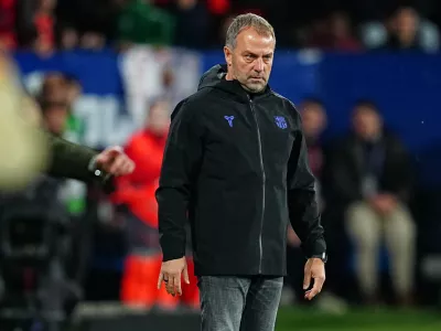 Barcelona's head coach Hansi Flick stands on the touchline during a Spanish La Liga soccer match between Osasuna and Barcelona in Pamplona, Spain, Saturday, May 2, 2026. (AP Photo/Miguel Oses)