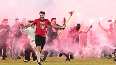 Fans get onto the pitch during the Czech league soccer derby match between Sparta Prague and Slavia Prague in Prague, Saturday, May 9, 2026. (Michal Kamaryt/CTK via AP)