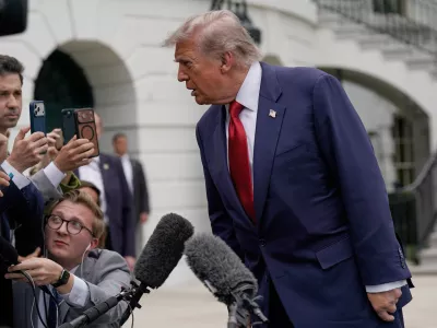 President Donald Trump speaks to reporters as he walks to board Marine One on the South Lawn of the White House, Friday, May 8, 2026, in Washington. (AP Photo/Jose Luis Magana)