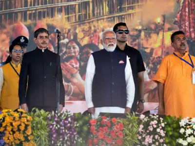 Indian Prime Minister Narendra Modi, centre, R. N. Ravi, Governor of West Bengal and Subhendu Adhikari, Chief Minister designate Bharatiya Janata Party leader stand for the national anthem prior to the oath taking ceremony in Kolkata, India, Saturday, May 9, 2026. (AP Photo/Bikas Das)
