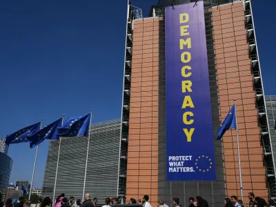 Visitors wait in line to get into an open house to celebrate Europe Day at EU headquarters in Brussels, Saturday, May 9, 2026. (AP Photo/Virginia Mayo)