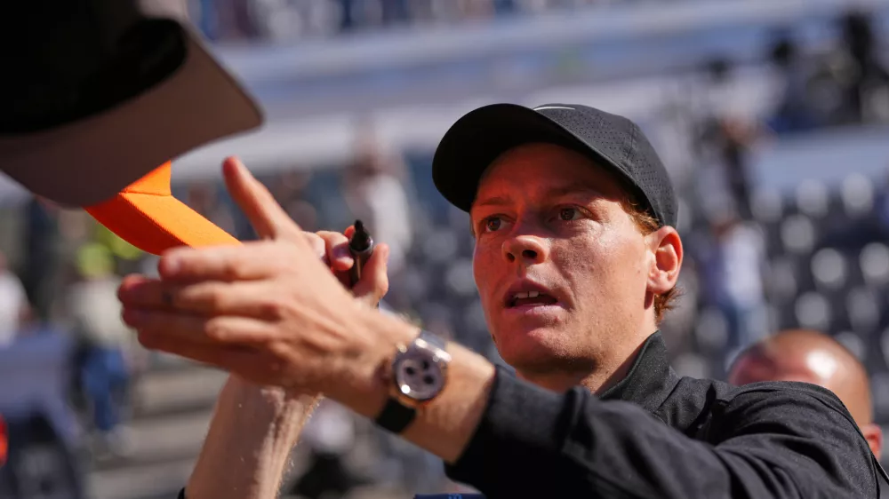 Italy's Jannik Sinner signs autographs after beating Australia's Alexei Popyrin 6-2, 6-0, after their match at the Italian Open tennis tournament in Rome, Monday, May 11, 2026. (AP Photo/Alessandra Tarantino)