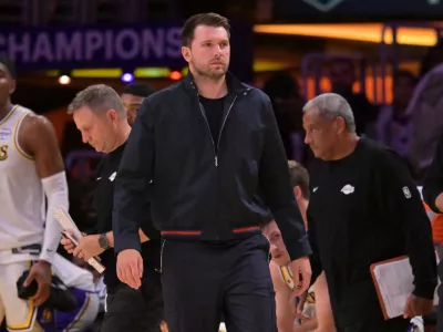 May 9, 2026; Los Angeles, California, USA; Los Angeles Lakers guard Luka Doncic (77) looks on from the bench in the final minutes of game three of the second round of the 2026 NBA Playoffs against the Oklahoma City Thunder at Crypto.com Arena. Mandatory Credit: Jayne Kamin-Oncea-Imagn Images
