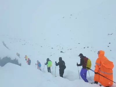 A screen capture from video shows trekkers leaving their campsite, as unusually heavy snow and rainfall pummeled the Himalayas, in the Tibet Region, China, October 5, 2025. Geshuang Chen/Handout via REUTERS. THIS IMAGE HAS BEEN SUPPLIED BY A THIRD PARTY NO RESALES. NO ARCHIVES. MANDATORY CREDIT