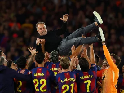 Soccer Football - LaLiga - FC Barcelona v Real Madrid - Spotify Camp Nou, Barcelona, Spain - May 10, 2026 FC Barcelona players throw coach Hansi Flick in the air as they celebrate after winning the LaLiga REUTERS/Albert Gea   TPX IMAGES OF THE DAY