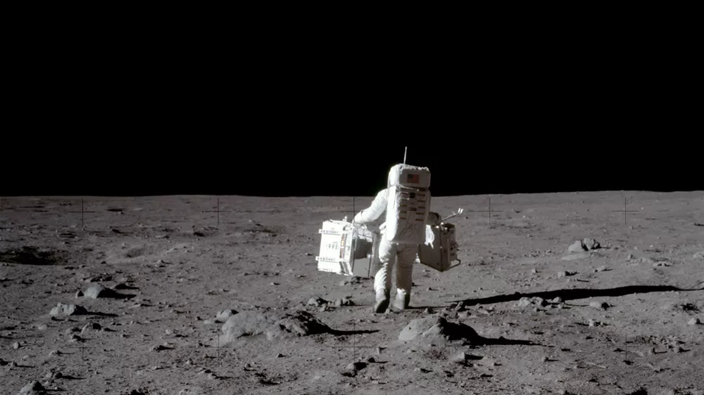 FILE PHOTO: Apollo 11 lunar module pilot Buzz Aldrin carries equipment for the Passive Seismic Experiments (in his left hand) and the Laser Ranging Retroreflector (in his right) to the deployment area at Tranquility Base in the Sea of Tranquility on the moon, July 20, 1969. Neil Armstrong/NASA/Handout via REUTERS/File Photo  ATTENTION EDITORS - THIS IMAGE HAS BEEN SUPPLIED BY A THIRD PARTY.  PLEASE SEARCH "50TH ANNIVERSARY OF THE MOON LANDING" FOR ALL PICTURES