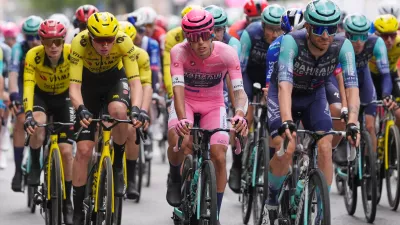 Portugal's Afonso Oliveira Eulalio wears the pink jersey of the race overall leader as he pedals in the pack, during the 6th stage of the Giro d'Italia cycling race, from Paestum to Naples, Italy, Thursday, May 14, 2026. (Fabio Ferrari/LaPresse via AP)