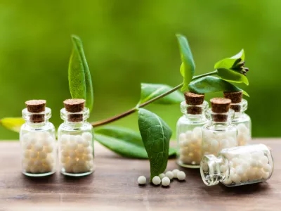 Classical Homeopathy globules in vintage bottles and nature leaves