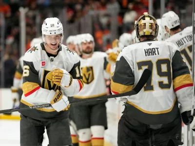 Vegas Golden Knights right wing Pavel Dorofeyev, left, celebrates his goal with goaltender Carter Hart during the third period in Game 6 of a second-round NHL hockey Stanley Cup playoff series against the Anaheim Ducks, Thursday, May 14, 2026, in Anaheim, Calif. (AP Photo/Mark J. Terrill)