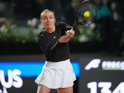 Ukraine's Elina Svitolina returns the ball to Poland's Iga Swiatek during their match at the Italian Open tennis tournament in Rome, Thursday, May 14, 2026. (AP Photo/Andrew Medichini)