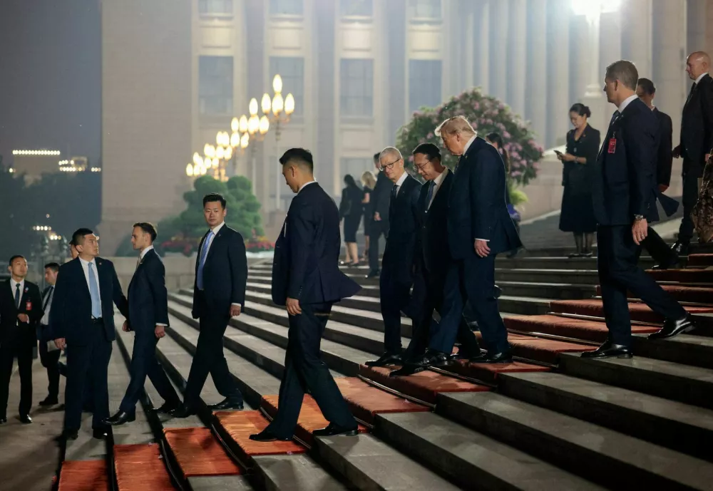 U.S. President Donald&nbsp;Trump, Chinese Vice Foreign Minister Ma Zhaoxu and Apple CEO Tim Cook walk outside the Great Hall of the People after attending a state banquet with Chinese President Xi Jinping (not pictured), in Beijing, China, May 14, 2026. REUTERS/Evan Vucci