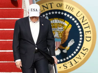 President Donald Trump walks down the stairs of Air Force One upon his arrival at Joint Base Andrews, Md., Friday, May 15, 2026. (AP Photo/Luis M. Alvarez)