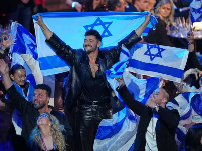 Noam Bettan from Israel, center, reacts as the points are awarded during the Grand Final of the 70th Eurovision Song Contest in Vienna, Austria, Sunday, May 17, 2026. (AP Photo/Martin Meissner)
