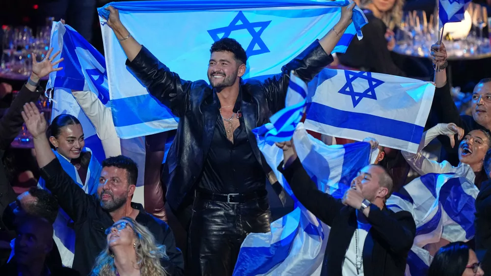 Noam Bettan from Israel, center, reacts as the points are awarded during the Grand Final of the 70th Eurovision Song Contest in Vienna, Austria, Sunday, May 17, 2026. (AP Photo/Martin Meissner)