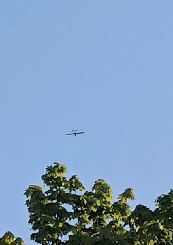 An aircraft flies over a village, after the Latvian military said a drone had entered the country's airspace, in Kubulova, Ludza, Latvia, in this still image obtained from social media video on May 17, 2026. Aleksejs Ivanovs/via REUTERS THIS IMAGE HAS BEEN SUPPLIED BY A THIRD PARTY. MANDATORY CREDIT. NO RESALES. NO ARCHIVES.  VERIFICATION: Reuters verified the location from the buildings, the road layout and the trees seen in the video, which matched archive and satellite imagery of the area. The date when the video was recorded was verified by the metadata on the original video file. A statement from the Latvian military confirmed that a drone entered and exited Latvian airspace on May 17.
