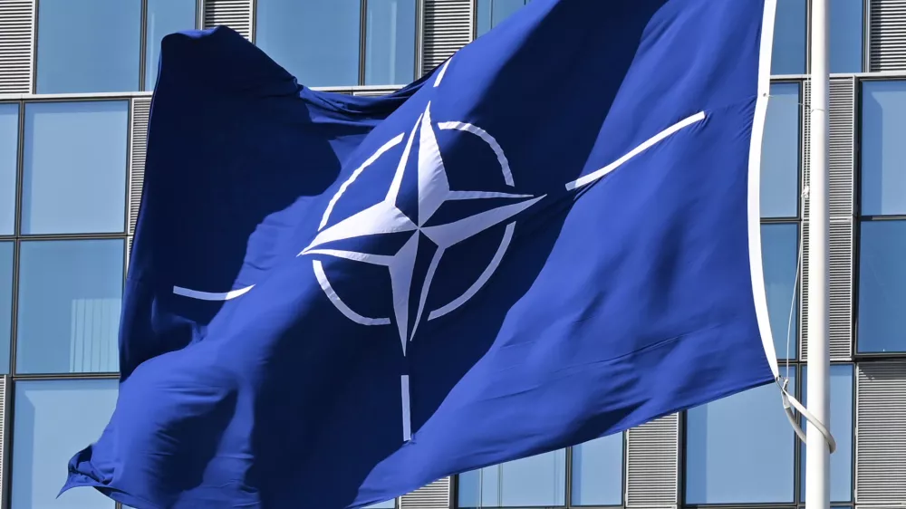 FILED - 03 April 2025, Belgium, Brussels: A NATO flag flies in the wind in front of the NATO headquarters in Brussels. Photo: Anna Ross/dpa