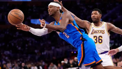 Oklahoma City Thunder guard Shai Gilgeous-Alexander, left, passes as Los Angeles Lakers guard Marcus Smart defends during the second half of Game 3 in a second-round NBA basketball playoffs series Saturday, May 9, 2026, in Los Angeles. (AP Photo/Mark J. Terrill)