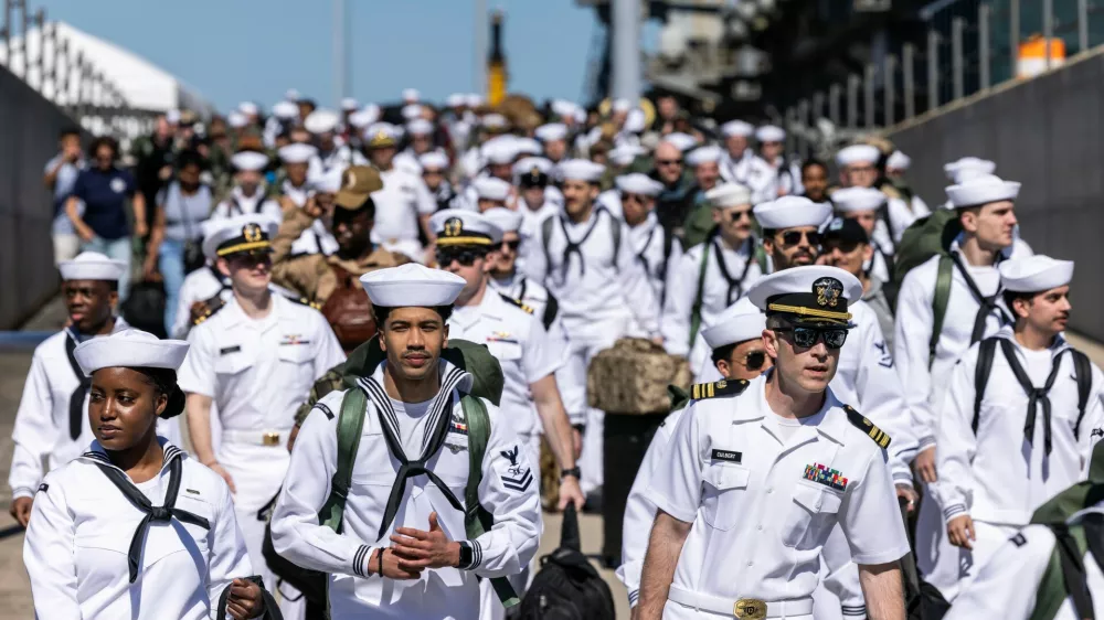 Sailors walk off of Pier 11 to find their loved ones after disembarking from the USS Gerald R. Ford at Naval Station Norfolk in Norfolk, Va. on Saturday, May 16, 2026, following an 11 month deployment. (Kendall Warner/The Virginian-Pilot via AP)