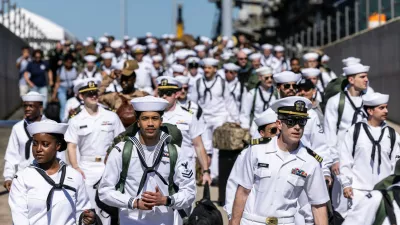Sailors walk off of Pier 11 to find their loved ones after disembarking from the USS Gerald R. Ford at Naval Station Norfolk in Norfolk, Va. on Saturday, May 16, 2026, following an 11 month deployment. (Kendall Warner/The Virginian-Pilot via AP)