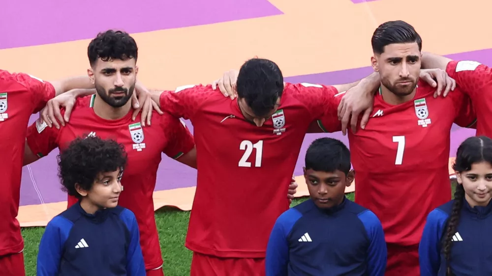 Soccer Football - FIFA World Cup Qatar 2022 - Group B - England v Iran - Khalifa International Stadium, Doha, Qatar - November 21, 2022 Iran's Ahmad Noorollahi, Sadegh Moharrami and Alireza Jahanbakhsh line up during the national anthems before the match REUTERS/Marko Djurica
