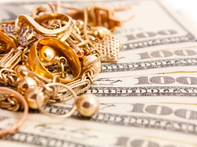 Closeup photo of jewelry on dollars. Isolated on white background.