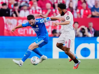 Real Madrid's Dani Carvajal, left, duels for the ball with Sevilla's Chidera Ejuke during the Spanish La Liga soccer match in Seville, Spain, Sunday, May 17, 2026. (AP Photo/Jose Breton)