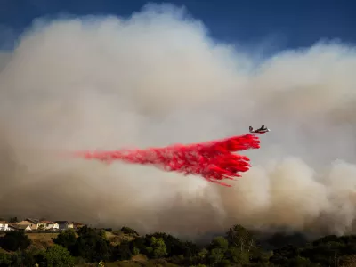 An air tanker drops retardant on the Sandy Fire on Monday, May 18, 2026, in Simi Valley, Calif. (AP Photo/Ethan Swope)