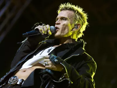 Britain's singer Billy Idol performs in the rain at the Sweden Rock festival in Solvesborg, Sweden, Friday June 11, 2010. (AP Photo/Claudio Bresciani/SCANPIX) ** SWEDEN OUT **