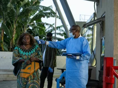 A Congolese health worker checks the temperature to screen a traveller at the Grande Barrier border following confirmation of an Ebola outbreak involving the Bundibugyo strain, at the border crossing point between Congo and Rwanda, in Goma, Democratic Republic of Congo May 18, 2026. REUTERS/Arlette Bashizi