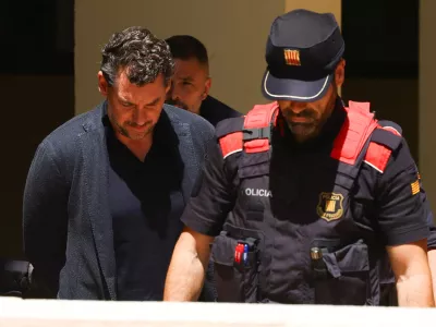 Jonathan Andic, the son of the founder of the Mango fashion group, Isak Andic, arrives at court escorted by police, where he is expected to be questioned after being detained in an investigation of the death of his father, who was killed in a fall from a cliff near Barcelona in December 2024, in Martorell, Spain, May 19, 2026. REUTERS/Albert Gea