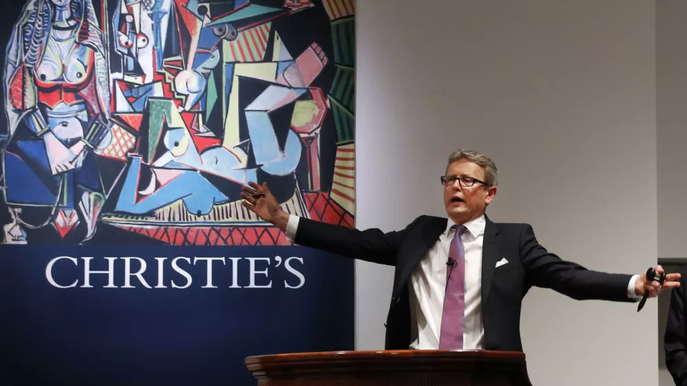 Auctioneer Jussi Pylkkanen takes bids on Pablo Picasso's Women of Algiers (Version O), which sold for nearly $179.4 million, making it set a world record for artwork at auction during a sale at Christie's Rockefeller Center in New York, Monday, May 11, 2015. Experts say high art prices are driven by artworks' investment value and by wealthy new and established collectors seeking out the very best works. (AP Photo/Kathy Willens)