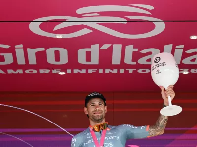 Cycling - Giro d'Italia - Stage 10 ITT - Viareggio to Massa - Italy - May 19, 2026 Netcompany INEOS's Filippo Ganna celebrates on the podium after winning Stage 10 ITT REUTERS/Jennifer Lorenzini