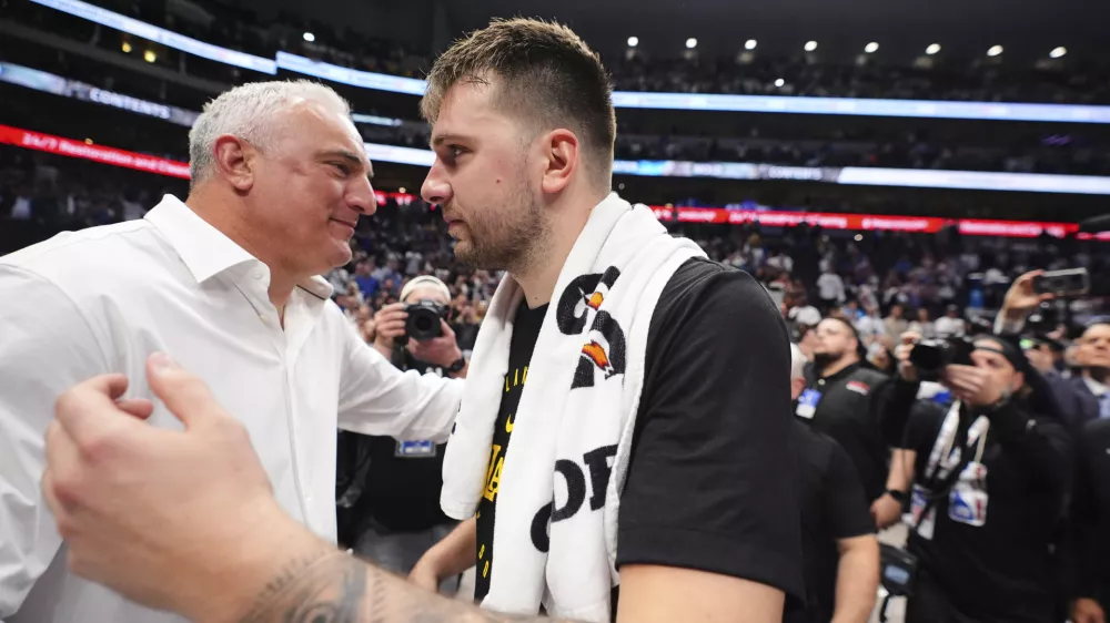 Los Angeles Lakers' Luka Doncic, right, hugs his father Sasa Doncic, left, following the team's NBA basketball game against the Dallas Mavericks in Dallas, Wednesday, April 9, 2025. (AP Photo/LM Otero)