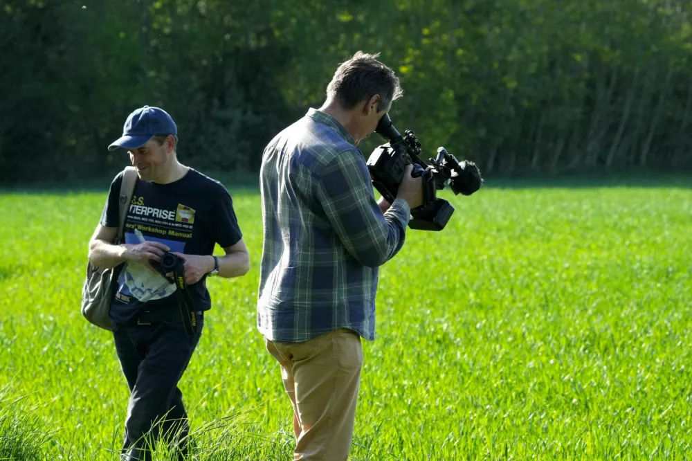 A cameraman films crashed drone debris at a site near Kablakula village, Estonia May 19, 2026. REUTERS/Ints Kalnins