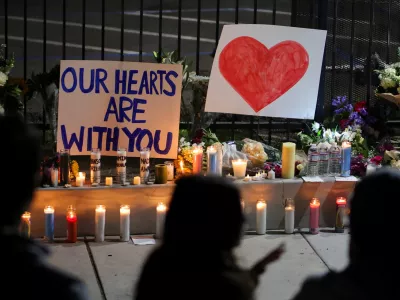 Candles and signs are placed on the ground as people pay their respects in front of the Islamic Center of San Diego after the vigil in a park, the day after a fatal shooting incident, in San Diego, California, U.S., May 19, 2026. REUTERS/Daniel Cole