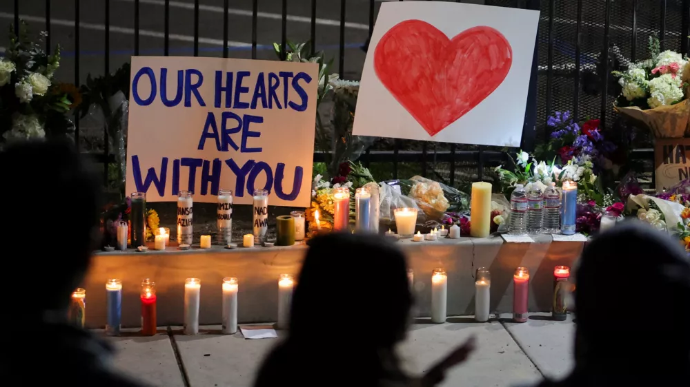 Candles and signs are placed on the ground as people pay their respects in front of the Islamic Center of San Diego after the vigil in a park, the day after a fatal shooting incident, in San Diego, California, U.S., May 19, 2026. REUTERS/Daniel Cole