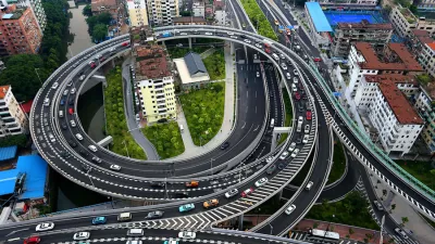 Aerial view of the two "nail houses" encircled by an overpass connecting the Zhoutouzui Tunnel in Guangzhou city, south China's Guangdong province, 11 August 2015.Images of two residential buildings surrounded by an overpass have gone viral in China. The houses were set to be demolished to create space for a bridge which would connect an elevated expressway to a newly opened underground tunnel in Guangzhou, Guangdong Province, reported China News Service. While most of the residents accepted the relocation compensation, three families refused to move out of their homes. The construction workers had no other choice but to build an overpass around the lonely "nail houses". The company has promised to surround the buildings with a noise barrier to make things more tolerable for the residents. Officials added that if the families should choose to move out later on, they would still be offered relocation packages.