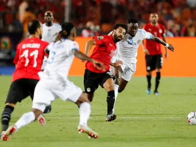 Soccer Football - Africa Cup of Nations 2019 - Group A - Egypt v DR Congo - Cairo International Stadium, Cairo, Egypt - June 26, 2019 DR Congo's Wilfred Moke in action with Egypt's Mohamed Salah     REUTERS/Mohamed Abd El Ghany