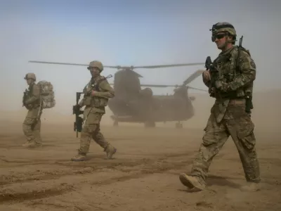 FILE - In this Jan. 28, 2012 file photo, U.S. soldiers, part of the NATO- led International Security Assistance Force (ISAF) patrol west of Kabul, Afghanistan. As the United States ends the nearly 20-year war in Afghanistan and as the Taliban recapture much of the country, Americans are asking if the longest war in their history was worth the cost. (AP Photo/Hoshang Hashimi, File)