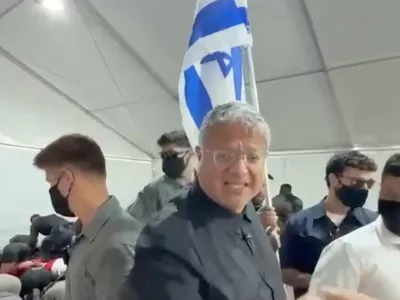Israeli National Security Minister Itamar Ben Gvir reacts as flotilla activists are detained by Israeli forces, in Ashdod Port, Israel, in this screen grab taken from a video released on May 20, 2026. Office Of Itamar Ben Gvir/Handout via REUTERS  THIS IMAGE HAS BEEN SUPPLIED BY A THIRD PARTY MANDATORY CREDIT VERIFICATION LINES: - Deck structure, bridge, stairs and container of the ship seen in video matched Reuters footage of an Israeli vessel arriving in Ashdod port on May 20 and reportedly carrying activists - Buildings and tent structures matched archive imagery of the Ashdod port and corroborating visuals - Identity of all the detained people could not be independently verified; however Reuters confirmed that some of them were part of the Global Sumud Flotilla by hair and facial features which matched visuals posted on social media by the activists  - Exact date could not verified, but no older version of the video was found posted online before May 20