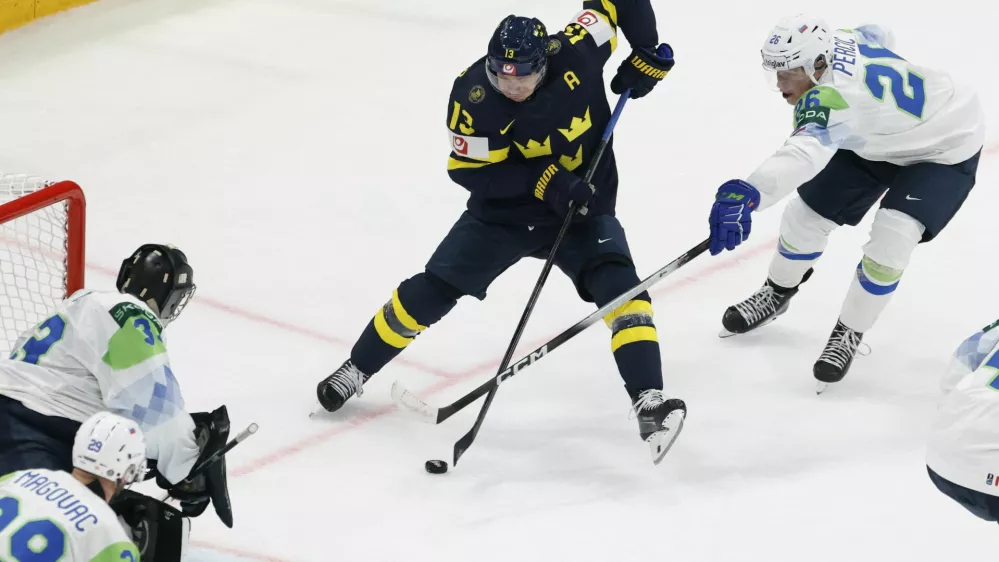 Ice Hockey - IIHF World Championships - Group B - Sweden v Slovenia - BCF Arena, Fribourg, Switzerland - May 20, 2026 Sweden's Lucas Raymond in action with Slovenia's Maks Percic REUTERS/David W Cerny