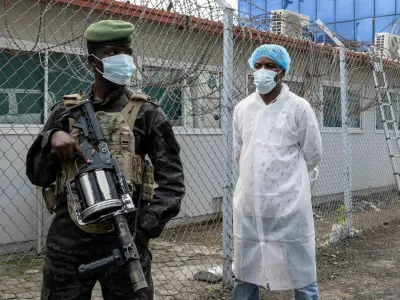 A member of the M23 rebel group stands guard outside a laboratory where samples from suspected Ebola cases are tested, in Goma, Democratic Republic of Congo, May 19. REUTERS/Arlette Bashizi Purchase Licensing Rights, opens new tab