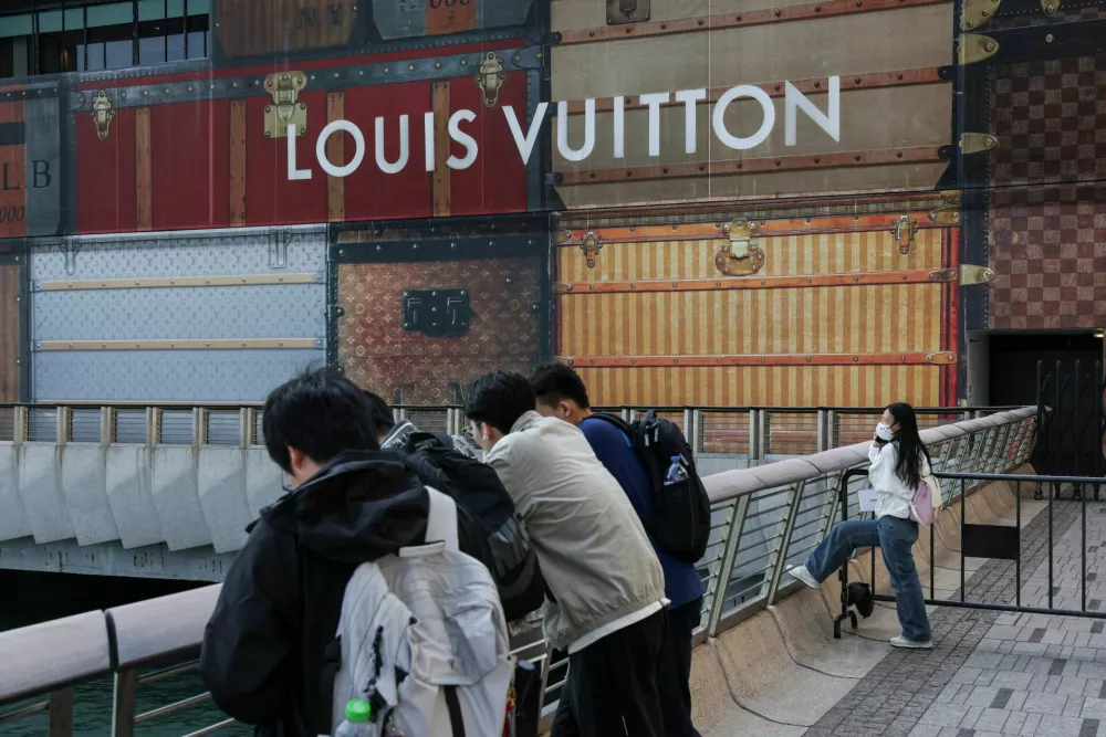 Tourists rest outside a Louis Vuitton store under renovation outside K11 MUSEA in Hong Kong, China, February 2, 2026. REUTERS/Tyrone Siu