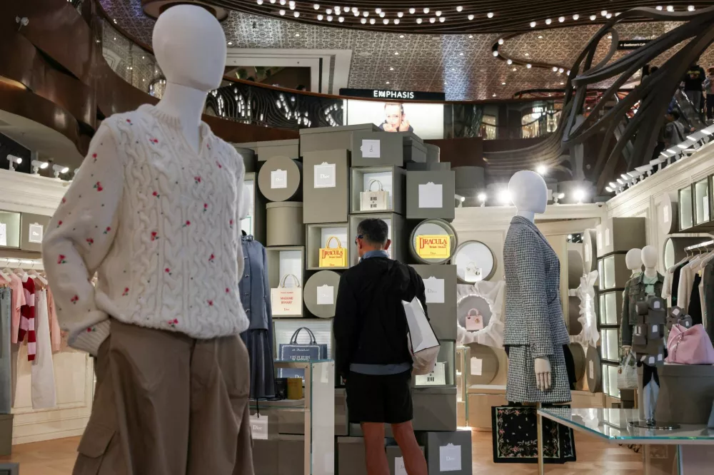 A customer looks at products inside a Dior store in K11 MUSEA in Hong Kong, China, February 2, 2026. REUTERS/Tyrone Siu