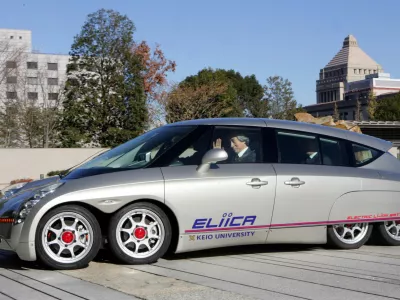 Japan's Prime Minister Junichiro Koizumi takes a ride in the eight-wheeled electric car "Eliica" at the premier's official residence in Tokyo December 19, 2005. Koizumi took a ride in the vehicle, which was developed by researchers at Keio University and uses lithium-ion battery as a power source with a top speed of 370 km (230 miles) per hour.  REUTERS/Yuriko Nakao
