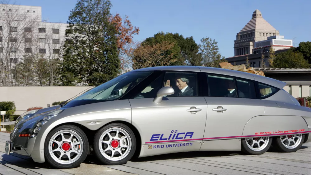 Japan's Prime Minister Junichiro Koizumi takes a ride in the eight-wheeled electric car "Eliica" at the premier's official residence in Tokyo December 19, 2005. Koizumi took a ride in the vehicle, which was developed by researchers at Keio University and uses lithium-ion battery as a power source with a top speed of 370 km (230 miles) per hour.  REUTERS/Yuriko Nakao